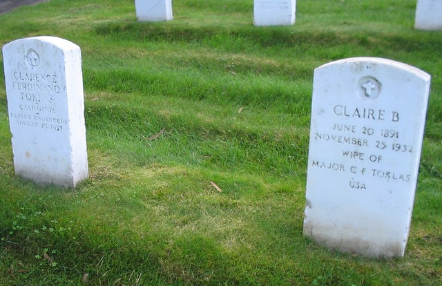 A group of headstones in a cemetery  Description automatically generated